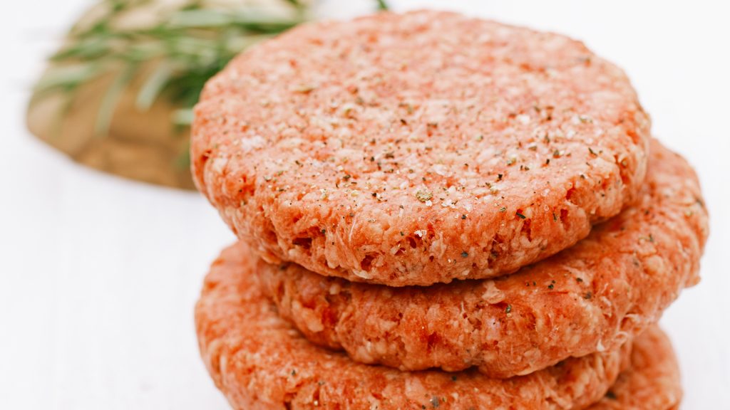 Raw burgers for hamburgers, in a pile